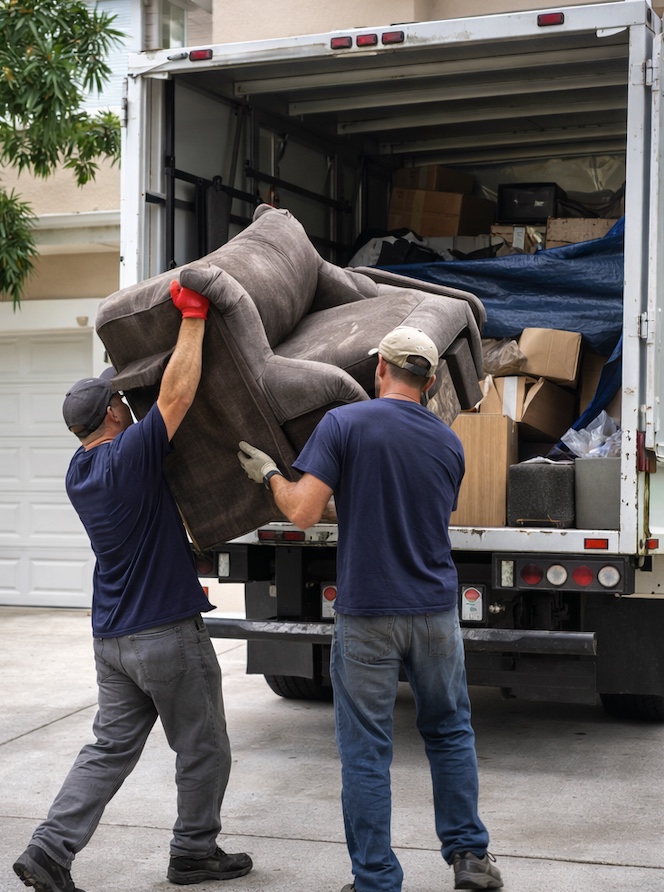 Junk removal crew loading furniture into a truck in West Palm Beach, Florida